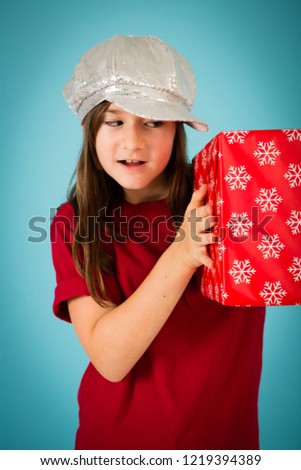 Christmas Girl Holding a Gift, Isolated on Teal