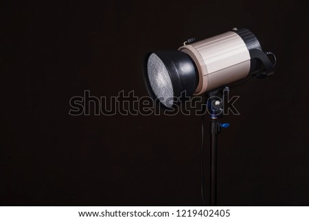 Close-up of professional studio light on the black background. Concept of photoshoot 