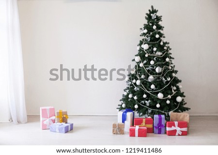 Christmas tree with Christmas gifts in white room
