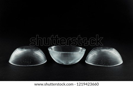 Composition with tree glass bowls on a dark background