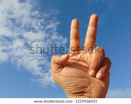 Symbolic hand with the blue sky background.