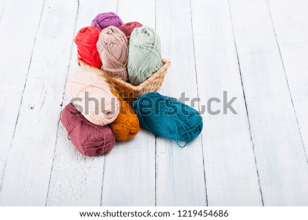 balls of wool on white wooden