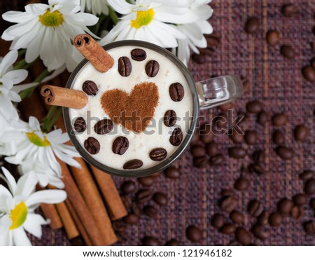 Cup of Cappuccino with Cinnamon and White Flowers