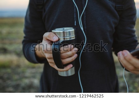 Thermos with warm black coffee. Royalty-Free Stock Photo #1219462525