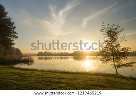 Beautiful sunrise at autumn morning in Katrineholm, Sweden Scandinavia. Lake, forest and nice sky. Calm, peaceful and joyful background image.