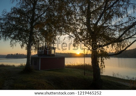 Beautiful sunrise at autumn morning in Katrineholm, Sweden Scandinavia. Lake, forest and nice sky. Calm, peaceful and joyful background image.