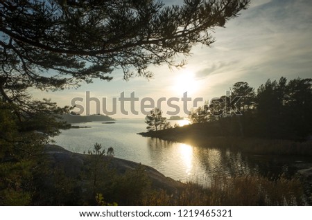 Beautiful sunset at autumn evening in Stendorren, Nykoping, Sweden Scandinavia. Sea, forest and nice sky. Calm, peaceful and joyful background image.