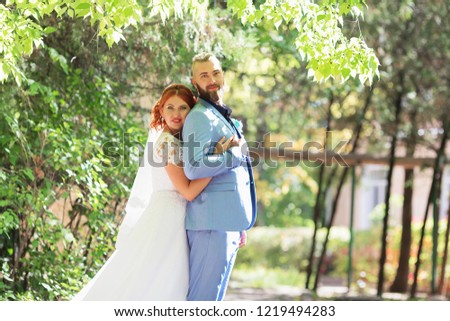 Just married loving hipster couple in wedding dress and suit in the park. Happy bride and groom walking running and dancing. Romantic Married young family. Autumn wedding