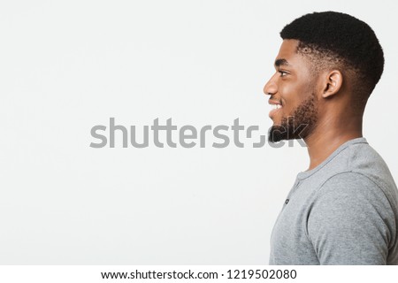 Happy smiling african-american man profile portrait. Black guy looking aside at copy space Royalty-Free Stock Photo #1219502080