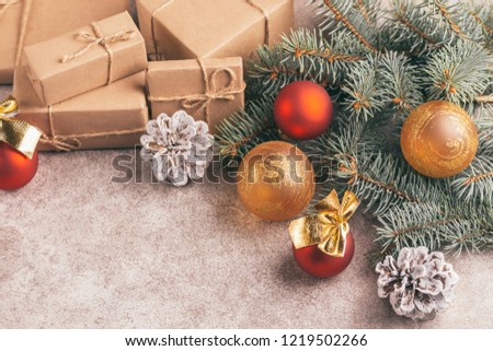 Craft gift boxes and Christmas decoration - Christmas tree branches and cones on slate marble background. Horizontal view. Copy space.