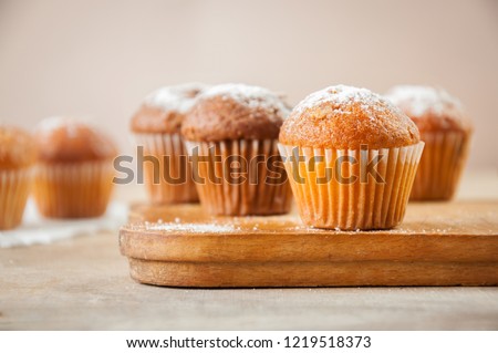 Tasty muffin closeup on a wooden board, selective focus. Royalty-Free Stock Photo #1219518373