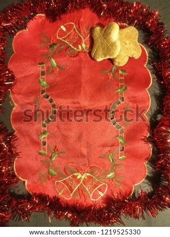
red cloth and corn cookies, red garlands around, black background in the picture.