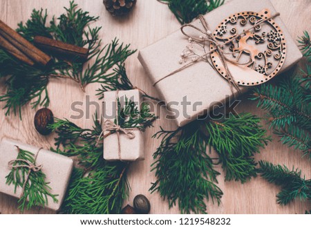 Christmas mood. Wrapped christmas gifts and decorations laid on wooden table background.