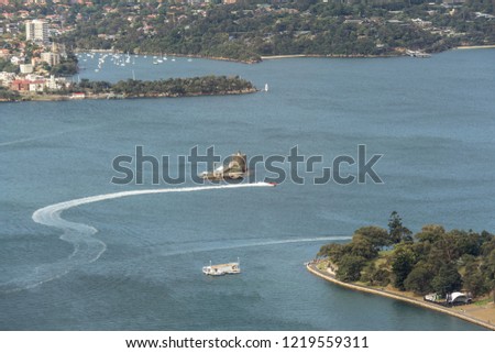 Aerial view of Fort Denison island, Martello Tower, in the harbour with waterfront architecture in Sydney, NSW, Australia