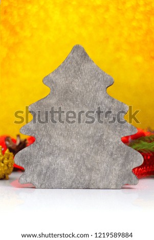 Wooden Christmas tree on a gold background. Laconic design of a Christmas card. A place for a label