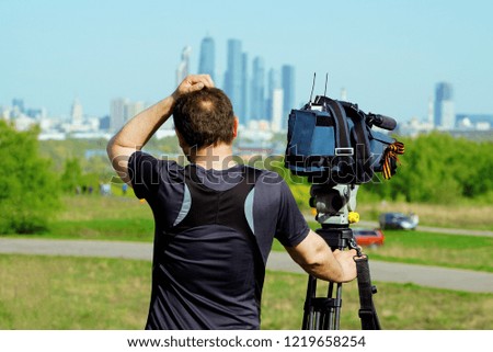 Videographer in nature. Summer, view of the city
