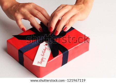 Woman wrapping a happy birthday gift box
