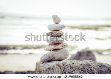 
Balanced Zen stones on blurred beach background, concept of balance and harmony