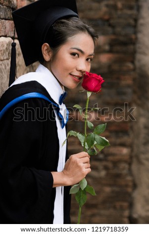 Portrait Female graduates wear blue graduation.