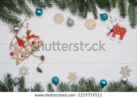 Christmas fir tree with decoration and glitters on wooden background. Christmas background on the white wooden desk