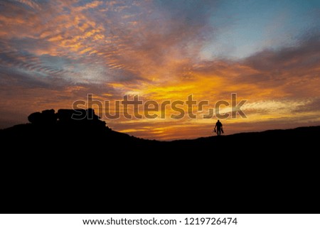 Silhouette of a nature photographer on a  colorful  sunset 