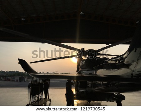 The helicopter was inspected by machanics in the morning prepare for flight. (blur picture)