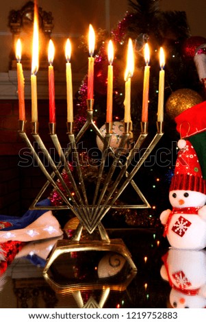 Minor candlestick on the background of a decorated Christmas tree