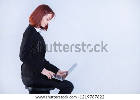 Young business woman working on laptop. Attractive mature businesswoman working on laptop. Girl working at the laptop. Studio.White background.