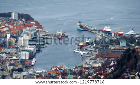 Bay of Bergen with cargo ships and harbor from aerial view.