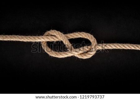 Figure Eight knot on black background. Rope node