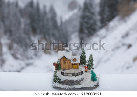 decorative Christmas house on the background of the winter landscape
