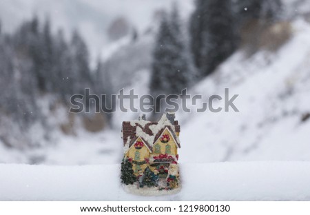 decorative Christmas house on the background of the winter landscape