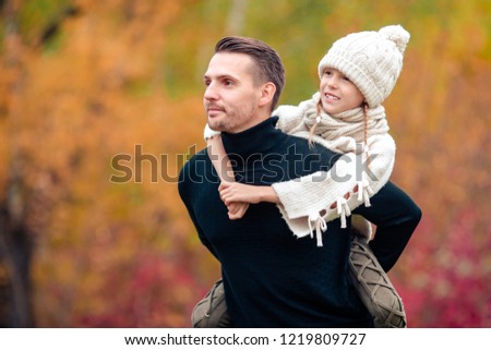Portrait of family of father and little kid at beautiful autumn day outdoors.