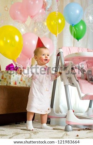 one-year-old little girl solemnize birthday with dirty-faced, stand, vertical photo
