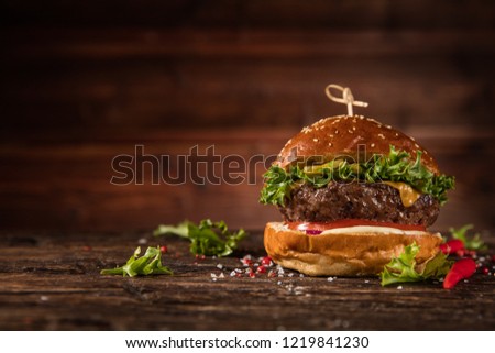 Delicious hamburger, served on wood. Free space for text