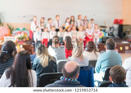 Children's holiday in kindergarten. Children on stage perform in front of parents. image of blur kid 's show on stage at school , for background usage. Blurry