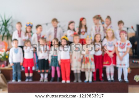 children perform at concert in primary school. Children's theatrical creativity, amateur performance in Kindergarten. Children's creativity. Children's choir in kindergarten. Blurry