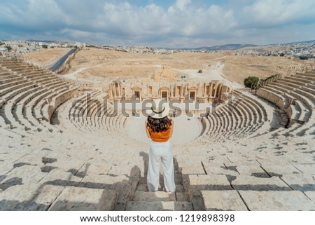 Back view of Asian young woman standing in front of South Roman Theatre, Jerash, Jordan Royalty-Free Stock Photo #1219898398