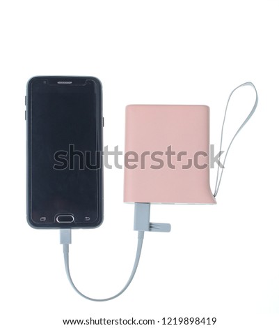 Modern smartphone charging from power bank isolated on white background. Gadgets for smartphones, external battery
