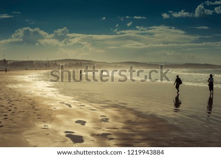 People are walking on a beautiful beach in Essaouira, Morocco