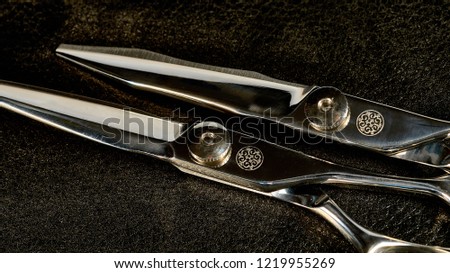 Pair of scissors on black background