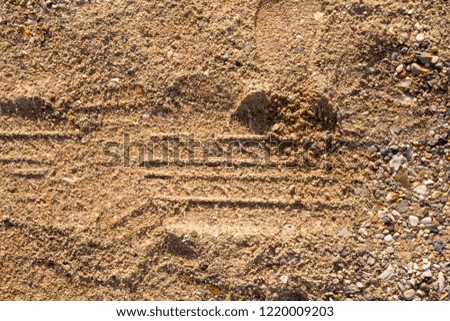sand texture, soil with patterns, tire tracks top view
