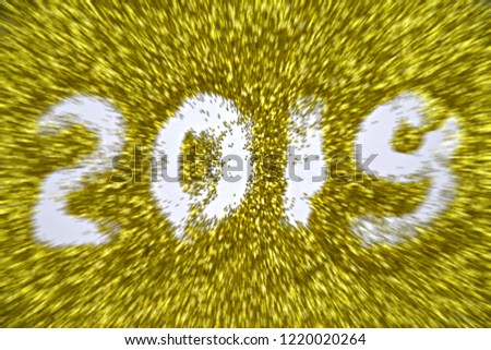 Blur zoom effects 2019 number or front yellow glitter abstract background texture with carborundum.Concept for holiday happy New Year.