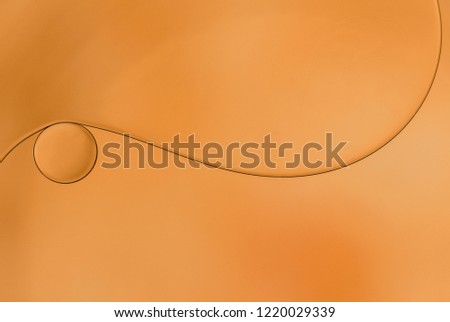 Macro photo of an oil drops on water surface.