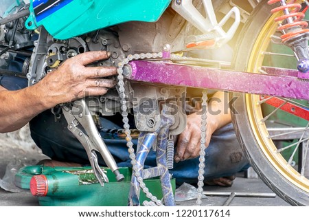 Motorcycle engine repair workers are working hard. To solve complicated mechanical engineering problems. The hand that smells oil.