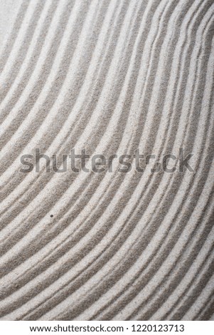 wavy curves on a sand- stone surface