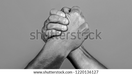 Man hand. Two men arm wrestling. Arms wrestling. Closep up. Friendly handshake, friends greeting, teamwork, friendship. Handshake, arms, friendship. Hand, rivalry, vs, challenge, strength comparison.