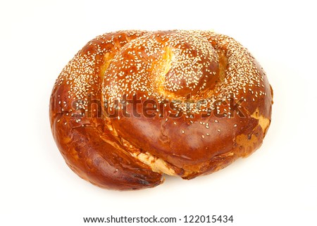 Sabbath challah with many white seeds isolated on white background