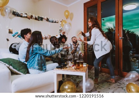 A group of young people celebrating and making party at home Royalty-Free Stock Photo #1220191516