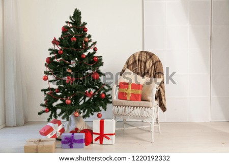 Christmas tree with presents in the room with a winter decoration for the new year